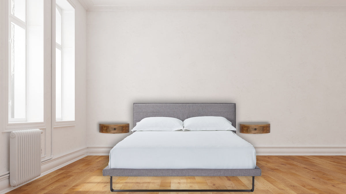 Wall Mounted Rounded Nightstand with 1 drawer, smooth rounded edges, and solid mango wood in oak-ish finish. View of two nightstands mounted n the wall beside a bed