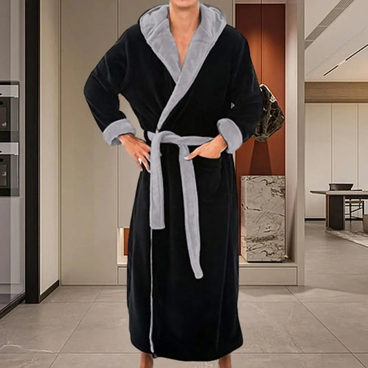 Person wearing a black and gray robe in a modern interior setting