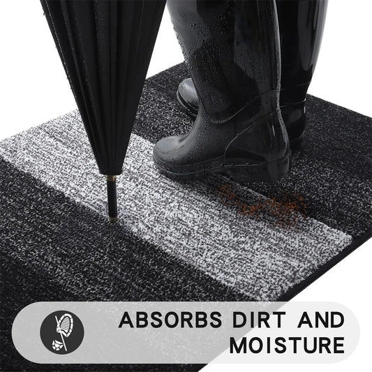 Person using a black umbrella on a textured mat with text 'Absorbs Dirt and Moisture'.