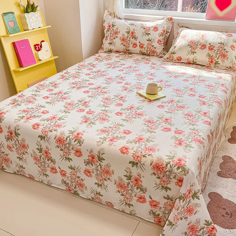 Floral bedspread on a bed with a yellow shelf in the corner.
