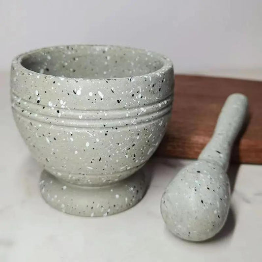 Speckled gray mortar and pestle on a white background