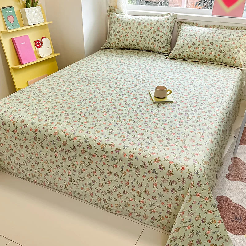 Floral patterned bedspread on a bed with a yellow shelf in the background