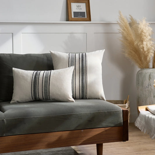 Gray sofa with striped cushions in a room setting