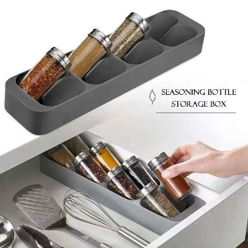 Gray seasoning bottle storage box with spice bottles inside, held by a hand.