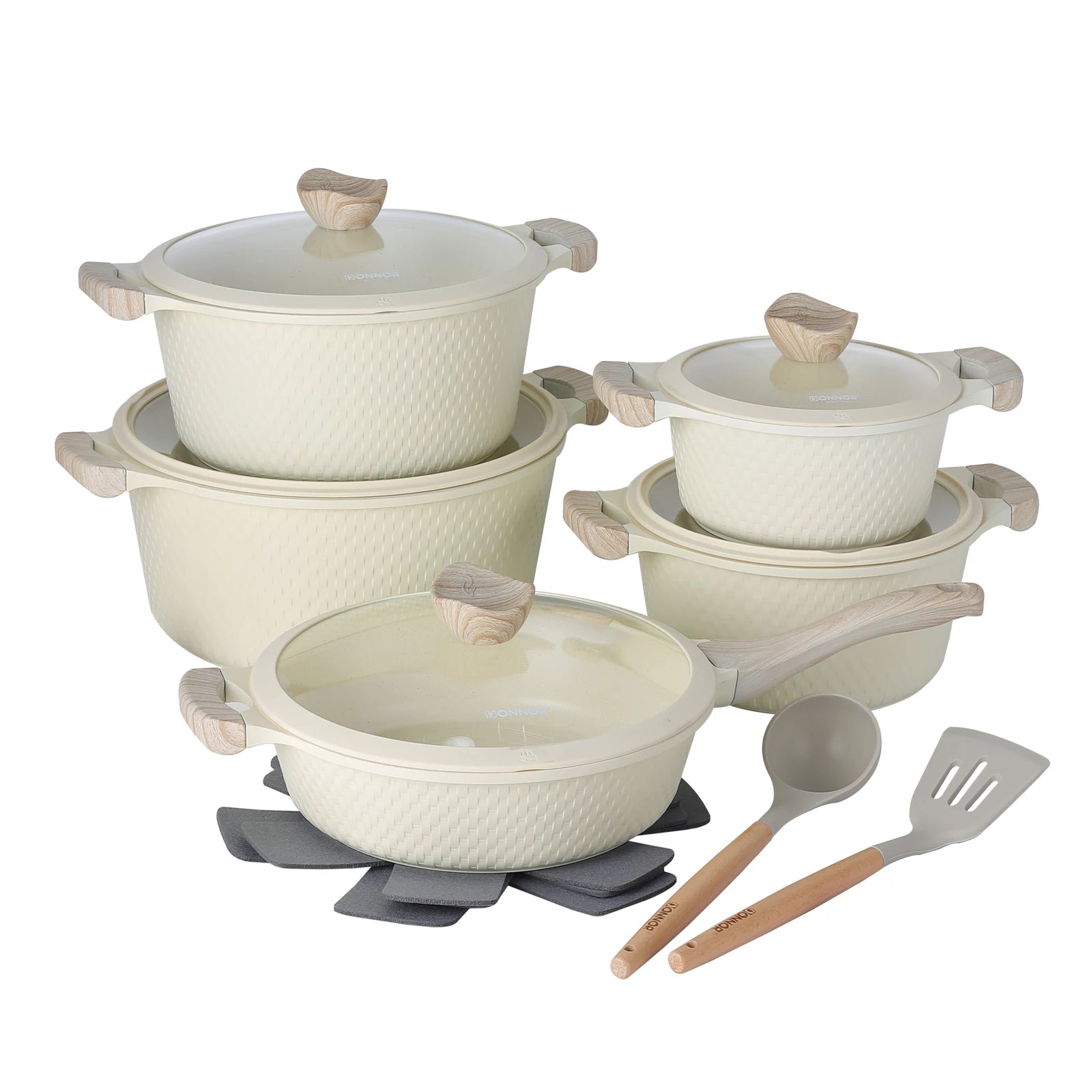 Set of ceramic cookware with lids and utensils on a white background
