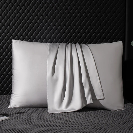 Silk pillowcase on a textured surface with a dark background