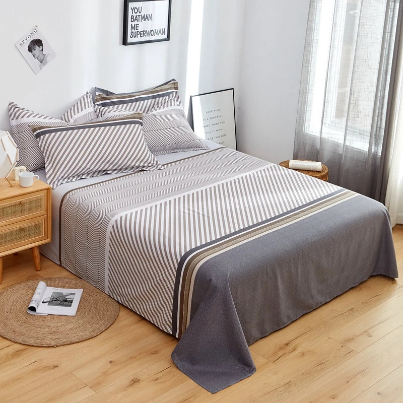 Bedroom with a bed covered in striped bedding and pillows, wooden nightstands, and a window with curtains.