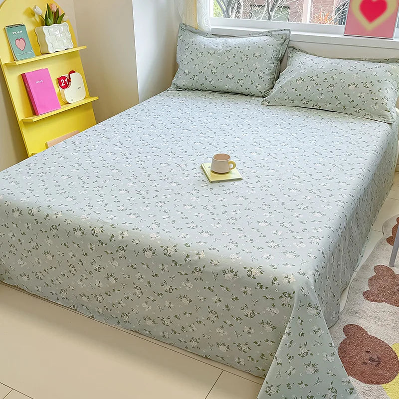 Bed with floral-patterned bedspread in a room with a yellow shelf and window.