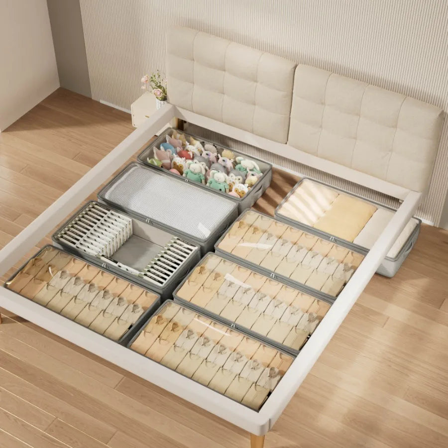 Bed with multiple storage drawers open, revealing organized items on a wooden floor.