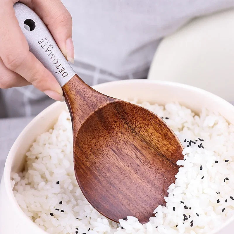 Wooden spoon with a metal handle labeled 'DETOX' being used to stir rice.