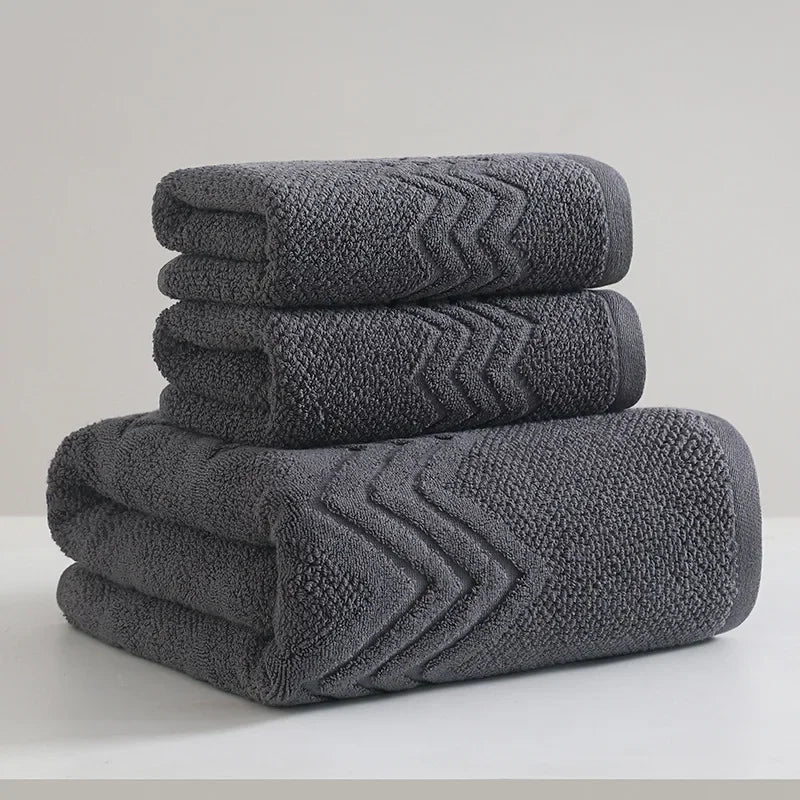 Stack of gray towels with textured pattern on a light background