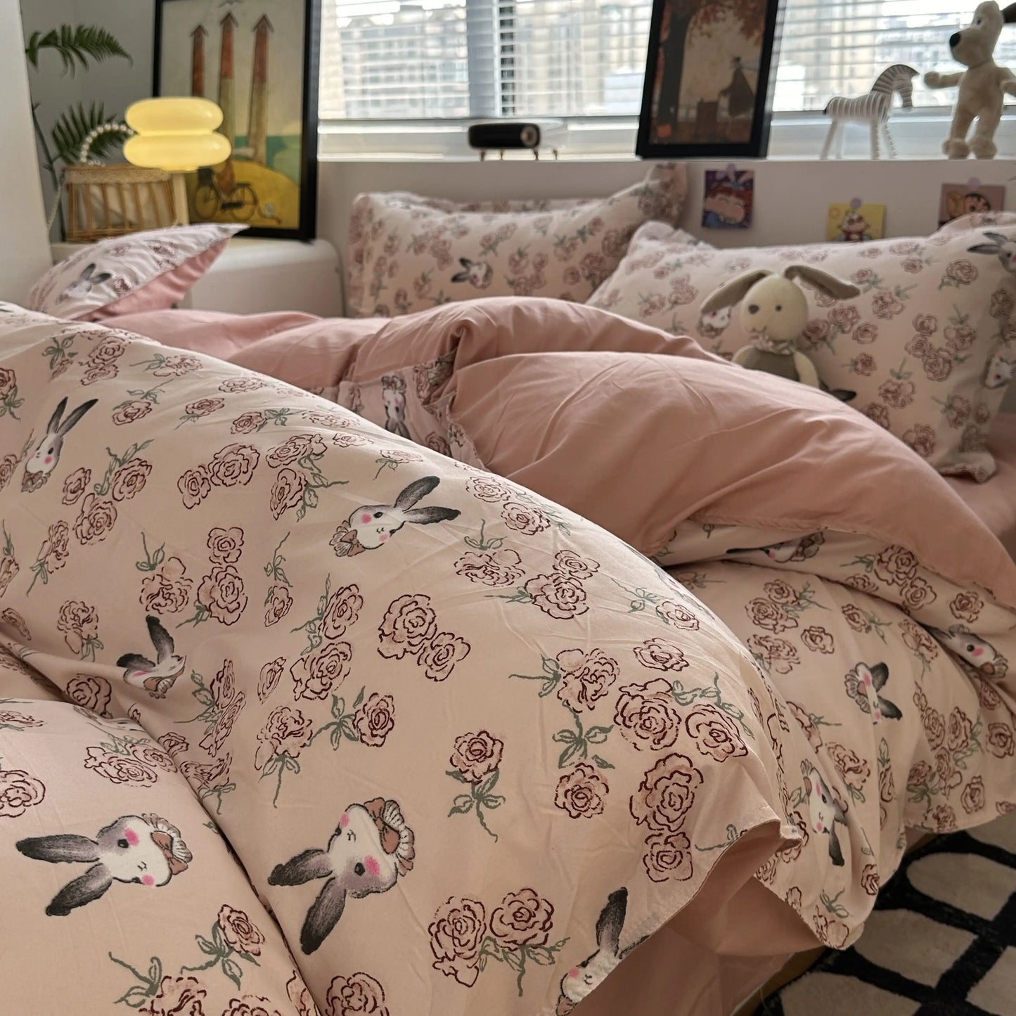 Floral and bunny-themed bedding set on a bed with a room in the background.