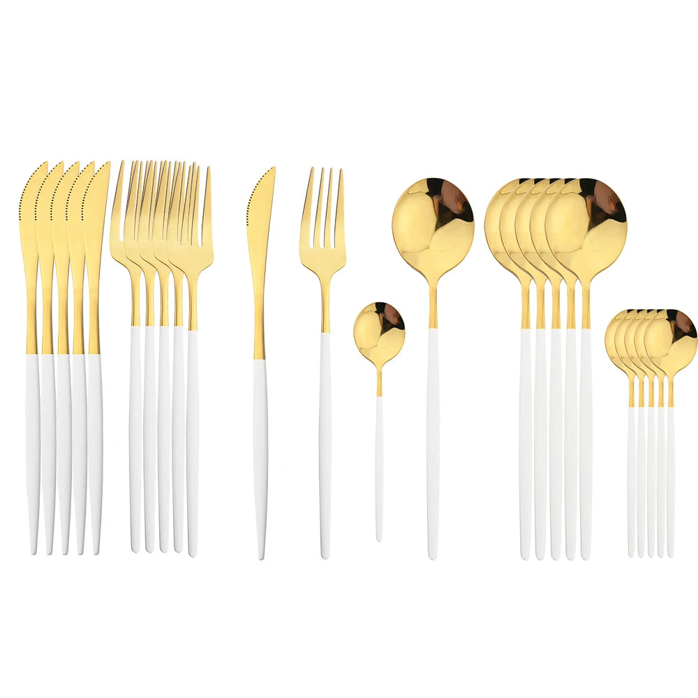 Gold and white cutlery set on a white background