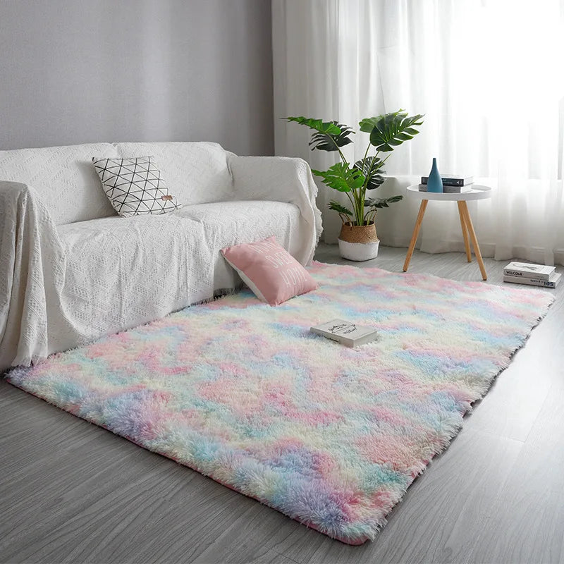 Multicolored rug on a wooden floor with a white sofa and decorative items in the background.
