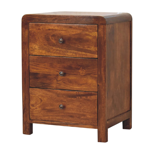 Naya Chestnut Nightstand made from solid mango wood with three drawers and brass knobs. Corner view
