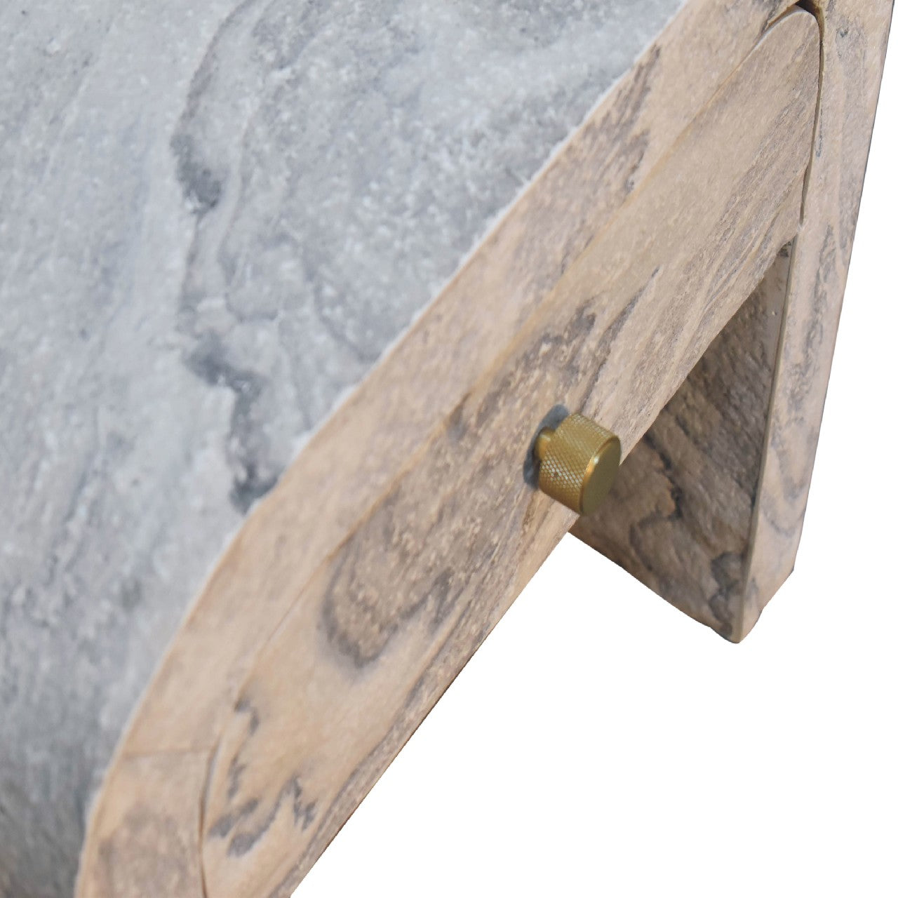 Nouveau nightstand with marble effect veneer, solid mango wood frame, and brass round knob. Bird eye view of the knob.