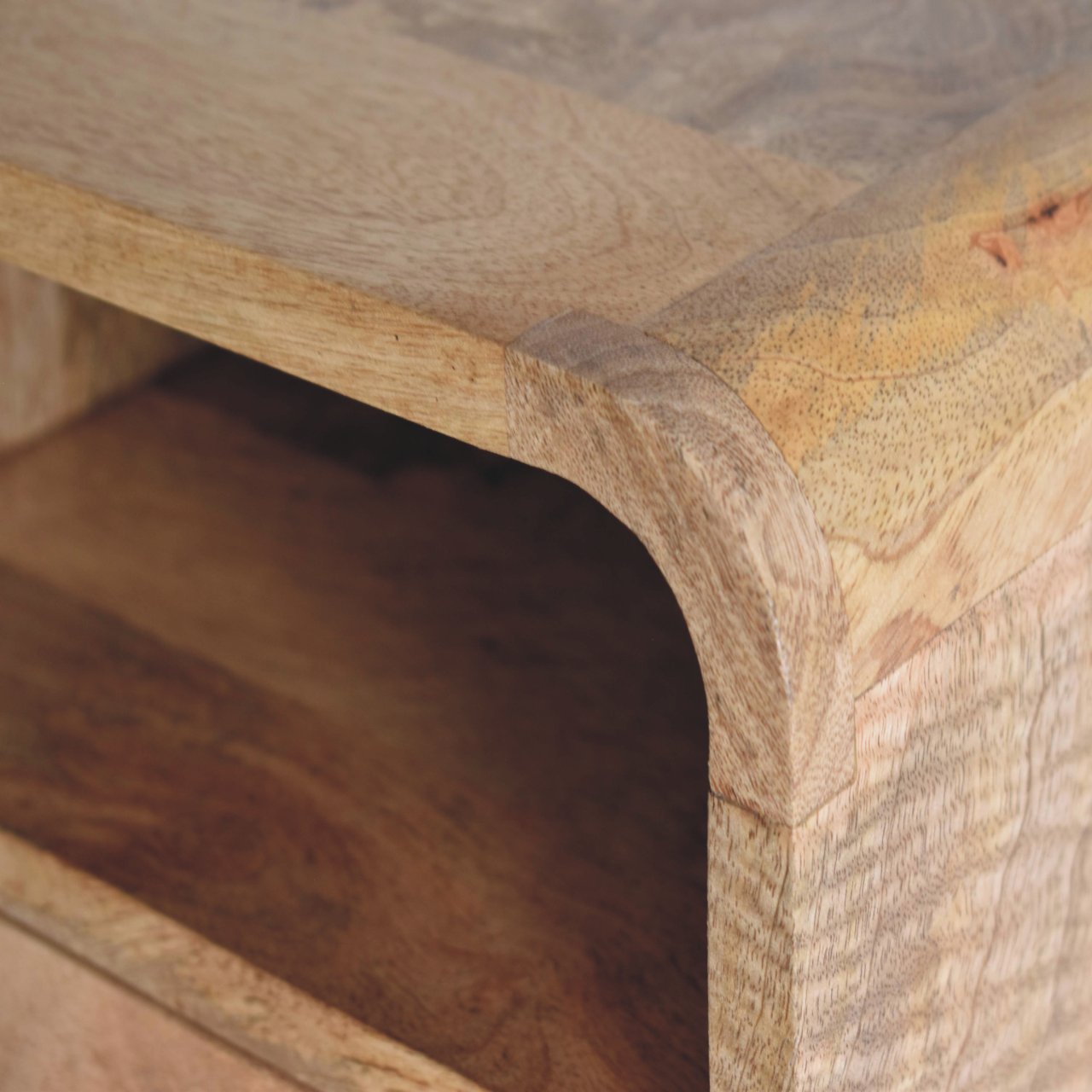 Extra Mini Wall Mounted Curved Oak-ish Bedside Table with one drawer and open lower shelf, solid mango wood. Table wood edge view