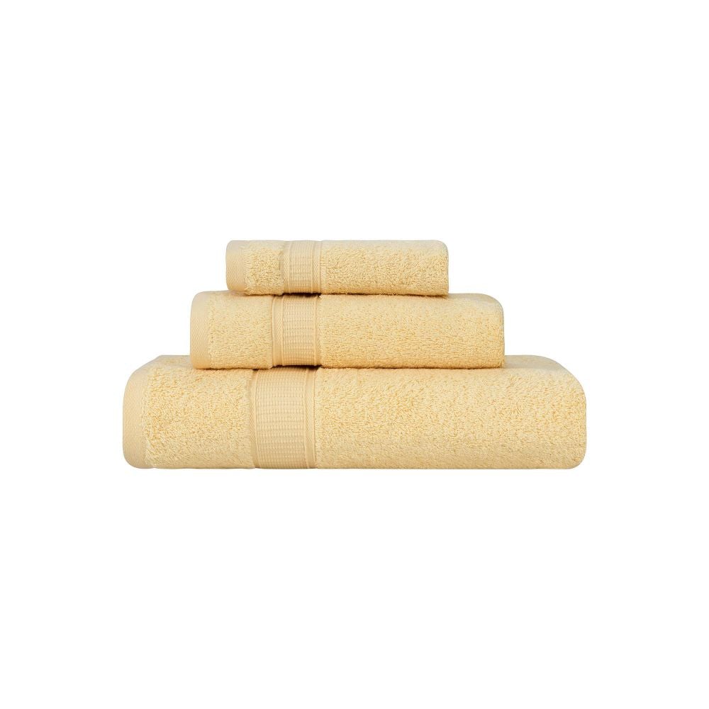 Set of beige towels stacked on a white background
