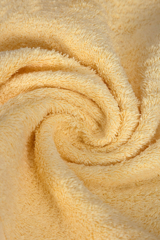 Close-up of a beige towel with a spiral pattern