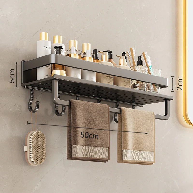 Bathroom shelf with toiletries, towels, and a brush on a beige wall.