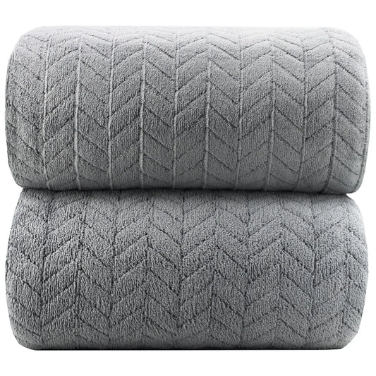 Two rolled-up gray textured blankets on a white background