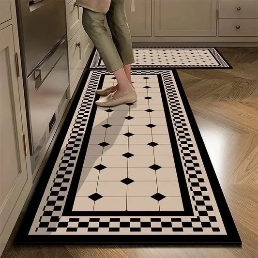 Person stepping onto a black and white patterned rug in a kitchen.