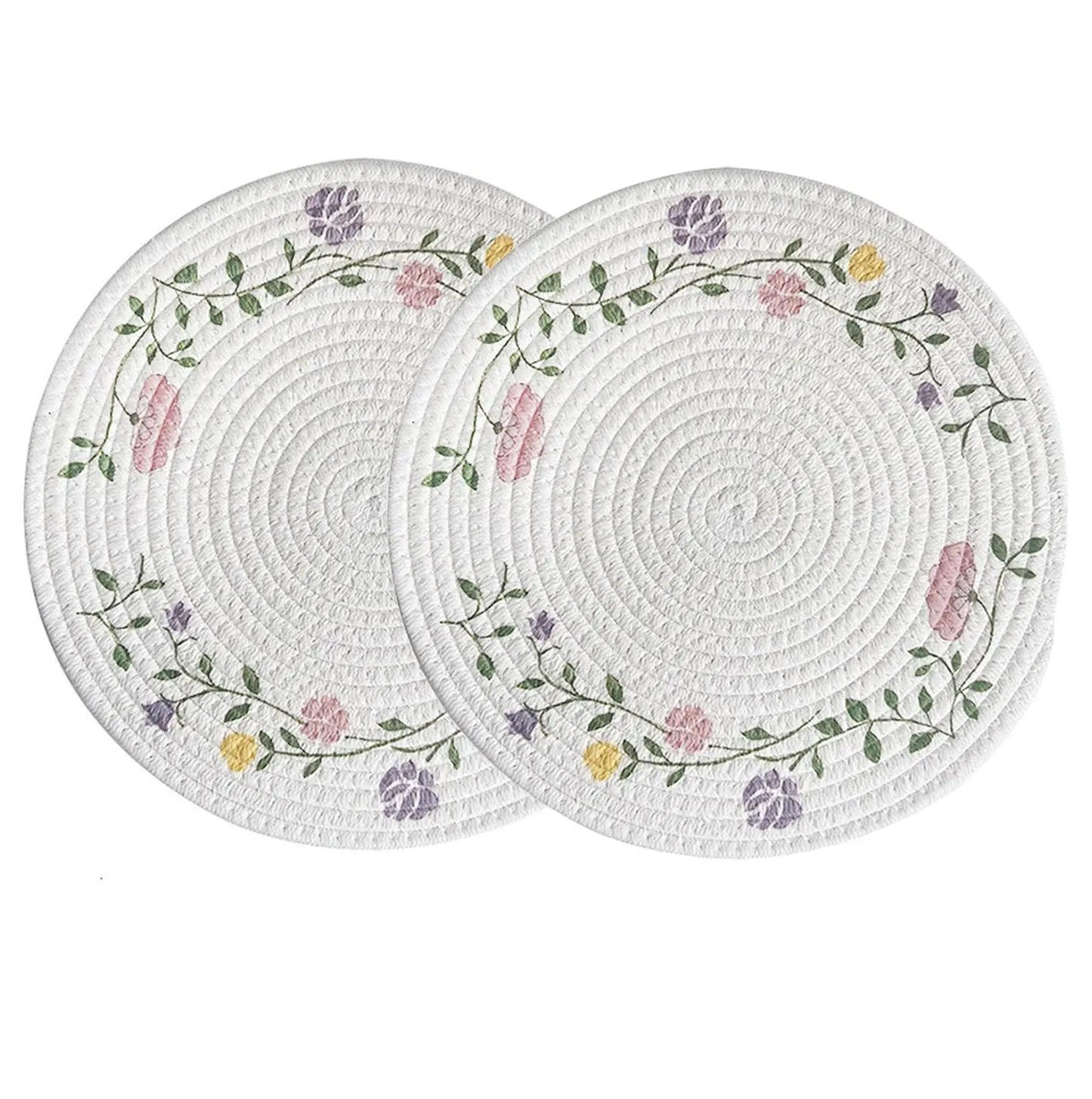 Two round woven placemats with floral patterns on a white background