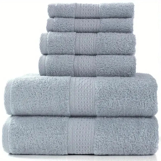 Set of six gray towels stacked on a white background