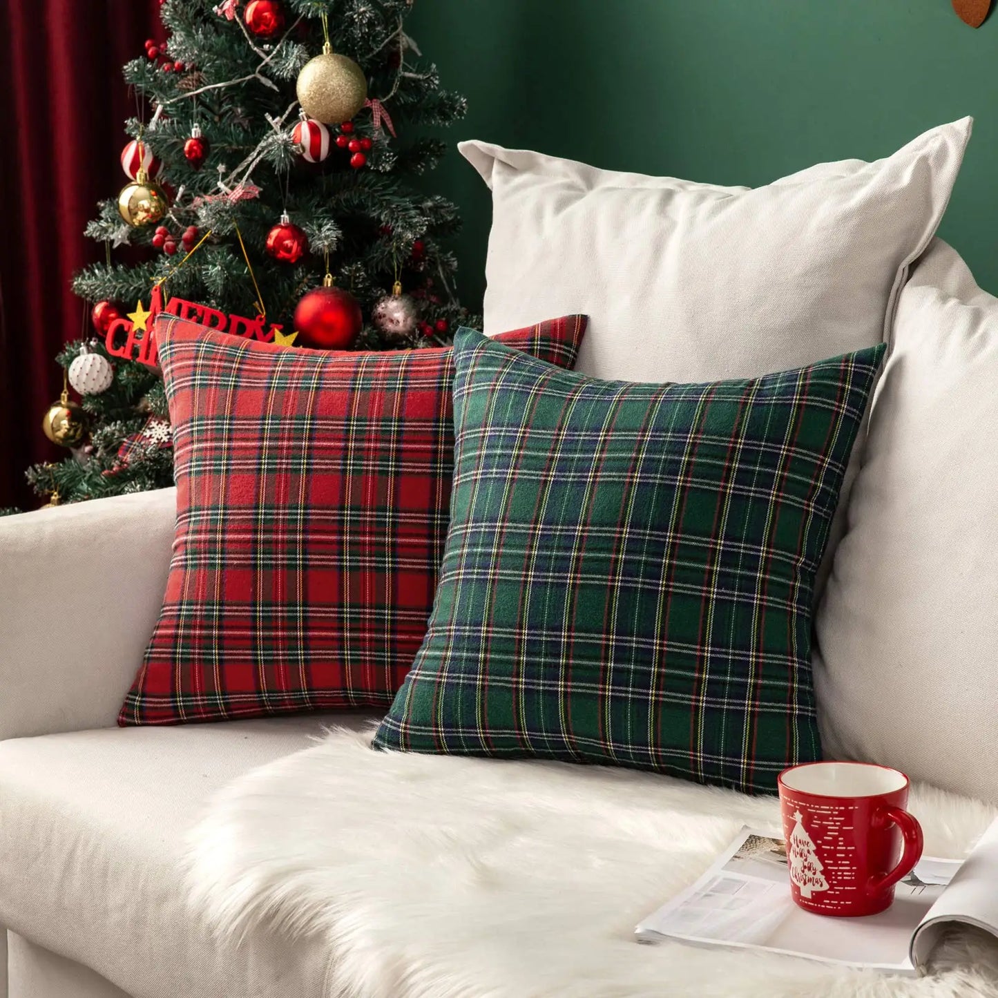 Plaid cushions on a sofa with a Christmas tree in the background