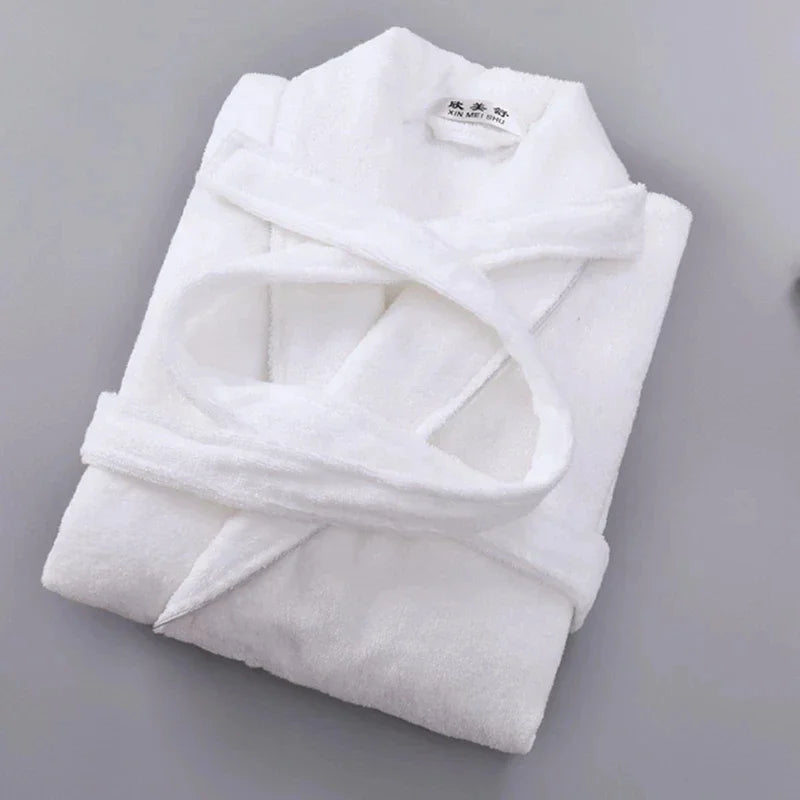 Folded white robe on a gray background