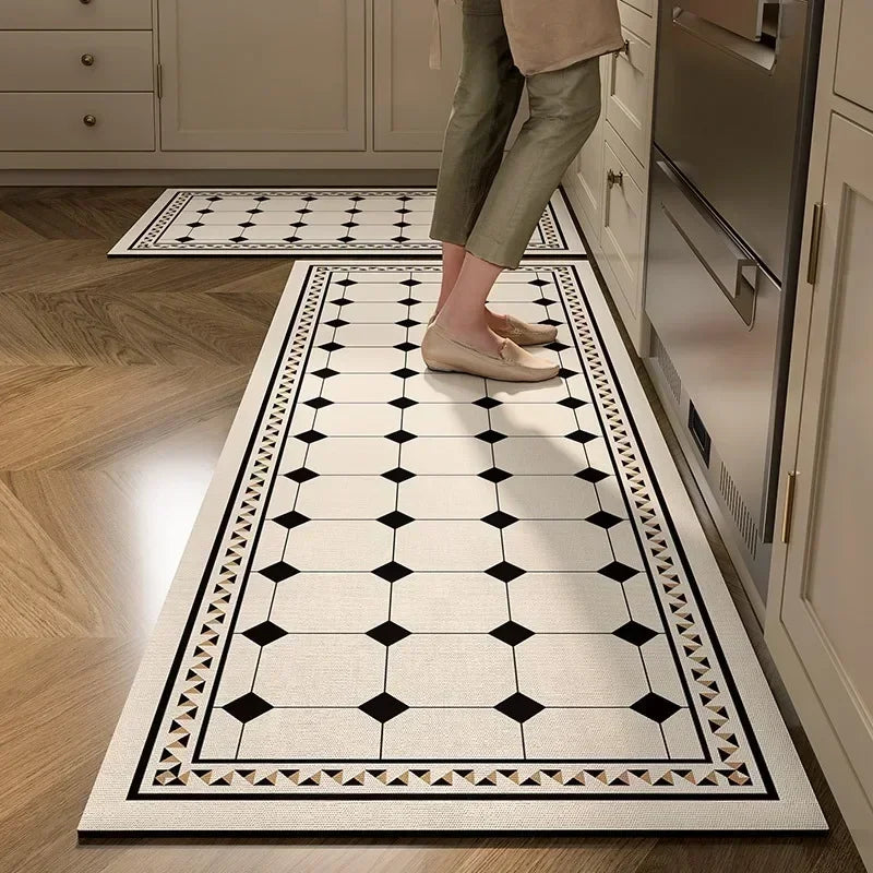 Person walking on a black and white patterned rug in a kitchen.