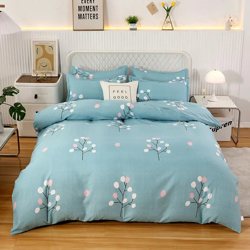 Blue floral patterned bedding set on a bed in a bedroom setting.
