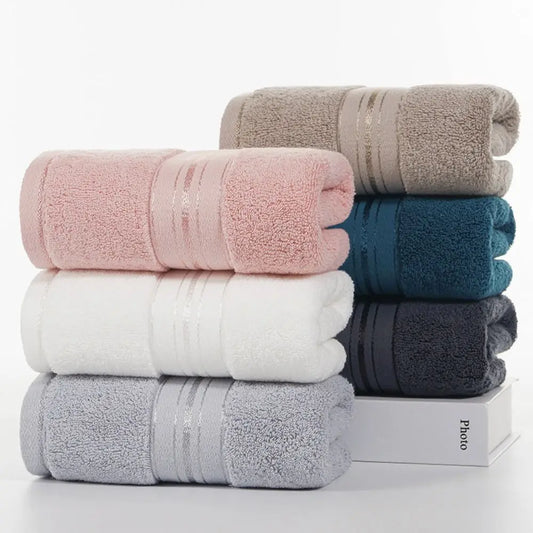 Stack of folded towels in various colors on a white background