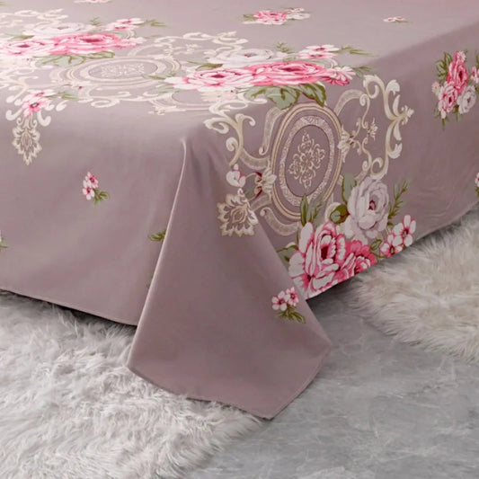 Floral patterned bedspread on a bed with a soft gray background