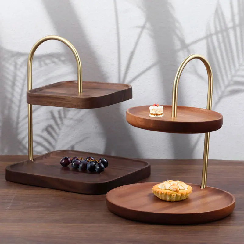 Wooden tiered tray with gold accents on a wooden surface.