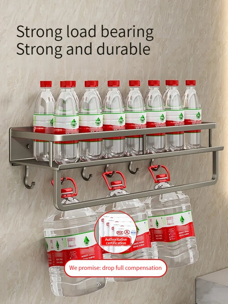 Wall-mounted shelf with water bottles and packaging on a beige wall.