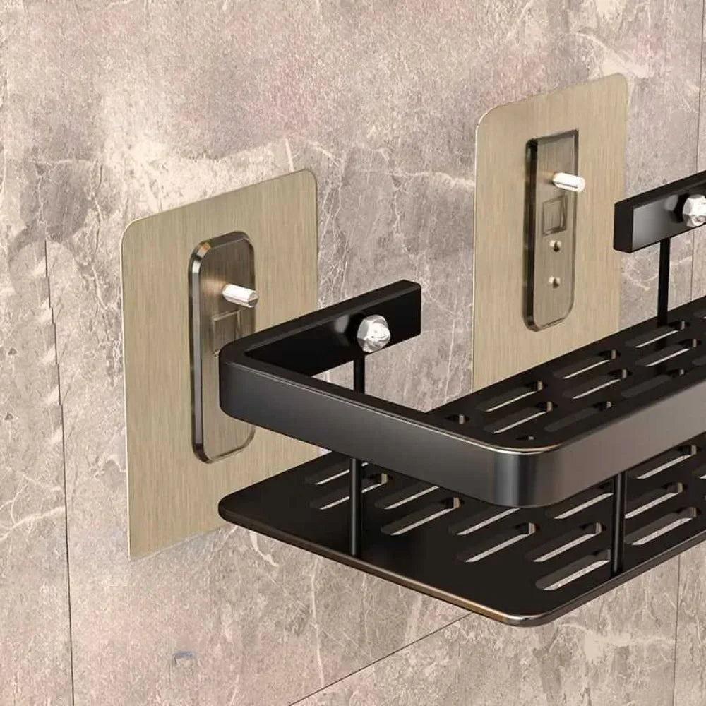 Black wall-mounted shower caddy with metallic brackets on a tiled wall.