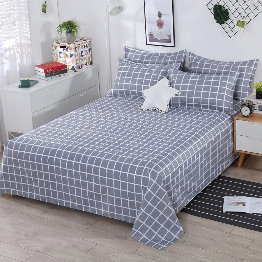 Bed with gray checkered bedding in a bedroom setting