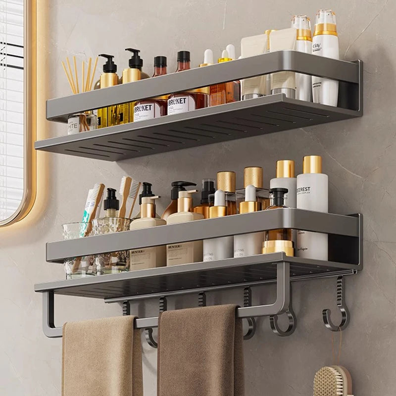 Bathroom shelf with toiletries and towels on a tiled wall