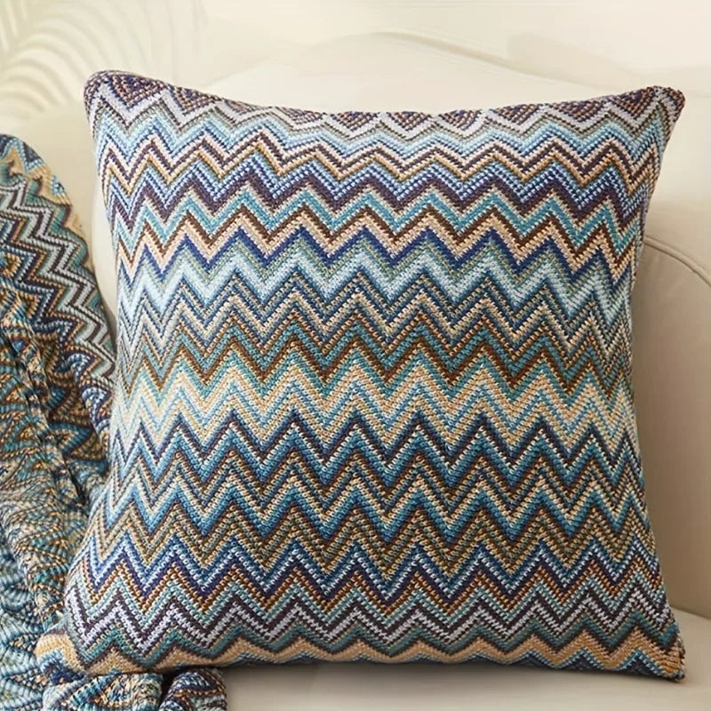 Decorative pillow with a zigzag pattern on a beige sofa