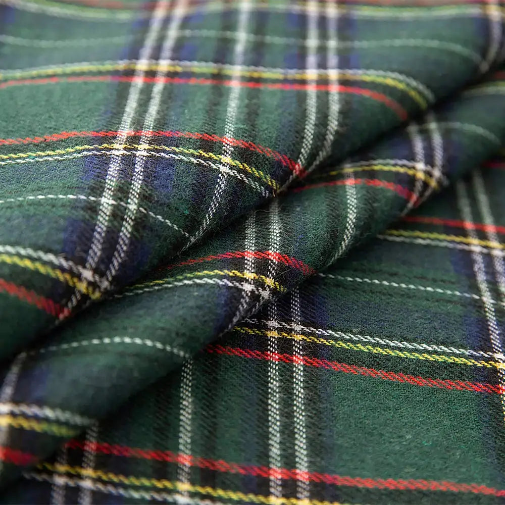 Close-up of plaid fabric with green, red, and blue colors.