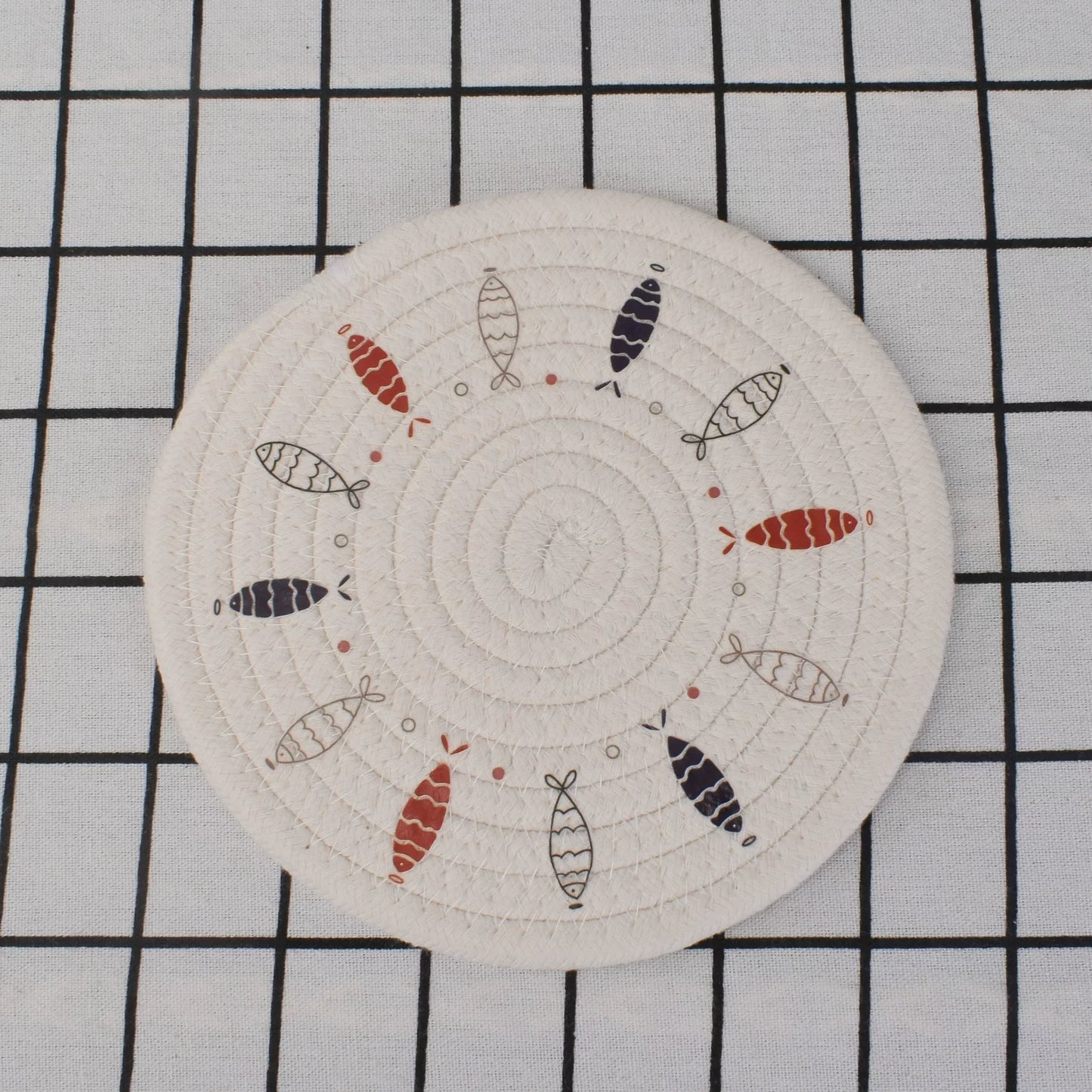 Circular patch with fish pattern on a grid background