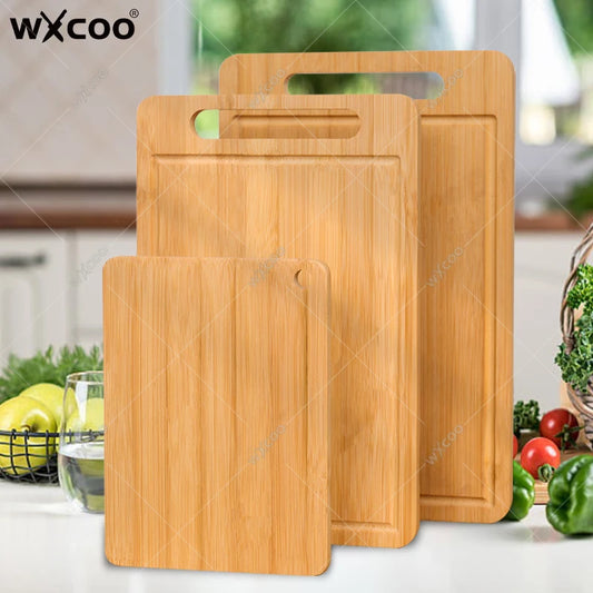 Set of wooden cutting boards with handles on a kitchen counter, featuring the brand 'Wxcoo'.