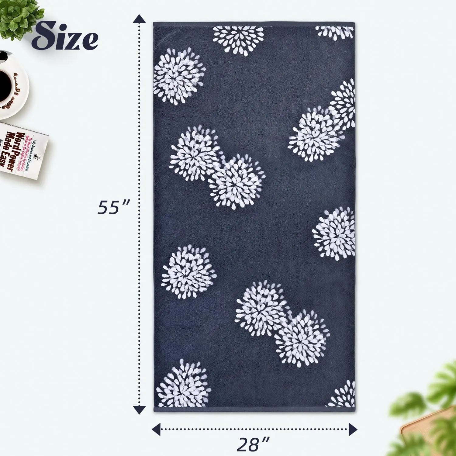 Navy blue towel with white floral patterns and measurements on a white background