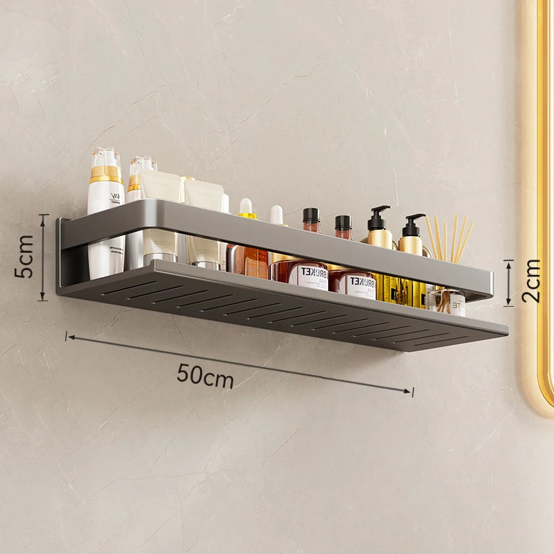 Wall-mounted metal shelf with cosmetic products on a neutral wall, showing dimensions.