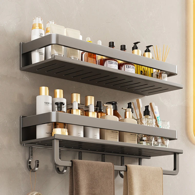 Bathroom shelf with various toiletries and towels on a neutral wall.