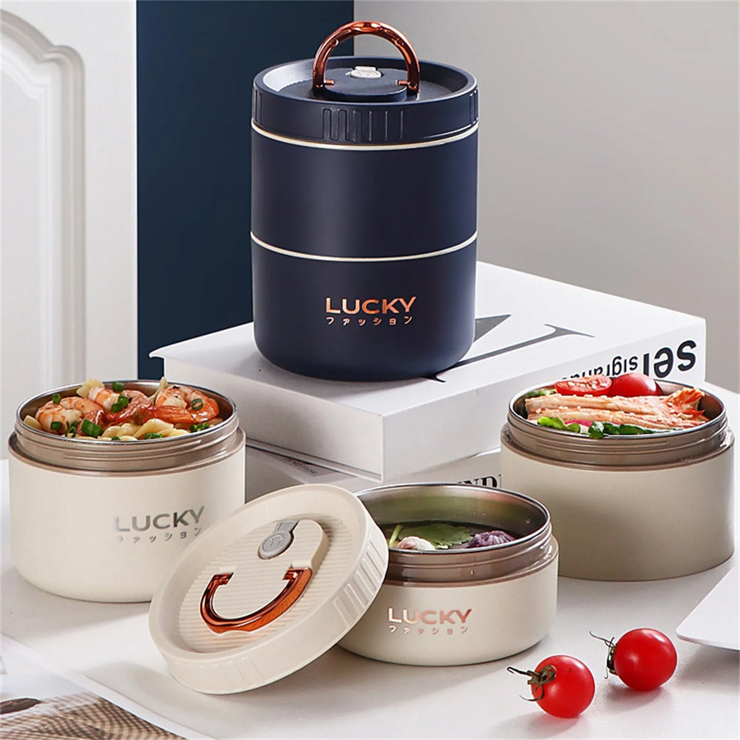 Set of Lucky brand food containers with food inside on a white surface.