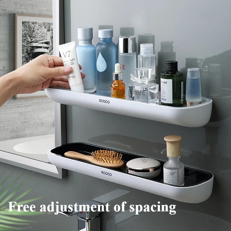 White wall-mounted shelf with various toiletries and a hand holding a bottle.