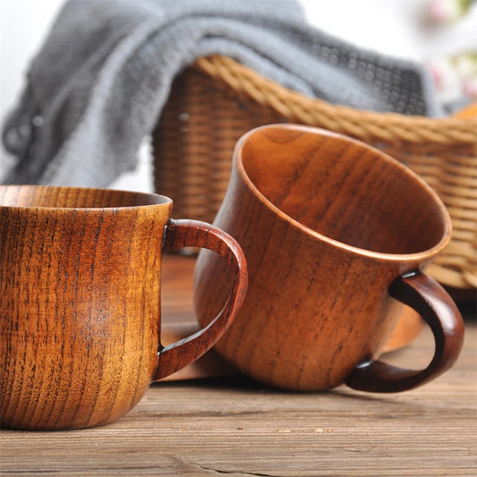 Two wooden mugs on a wooden surface with a blurred background