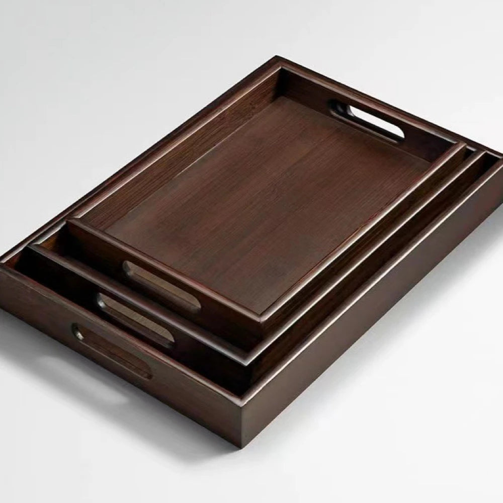 Set of wooden trays with handles on a light gray background